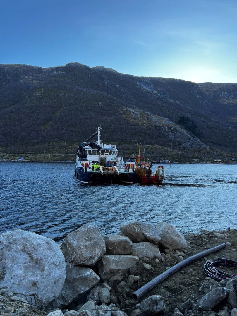 Installation vessel in Austgulfjorden, seen from the rocky landfall where the cable comes ashore