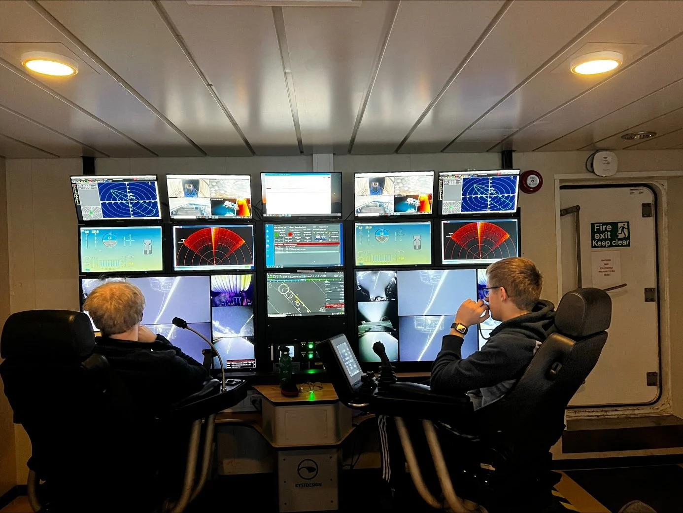 Two survey operators at the ROV control station aboard Olympic Triton