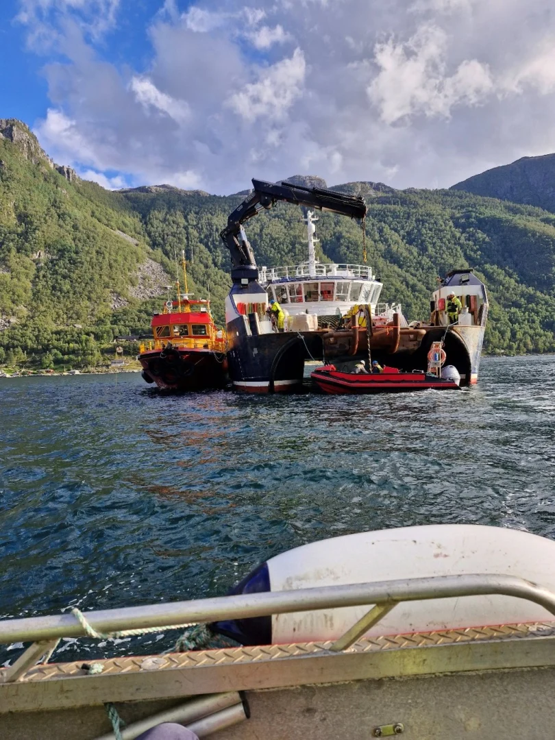 Installation vessel and workboats in Lysefjord, seen from a boat alongside